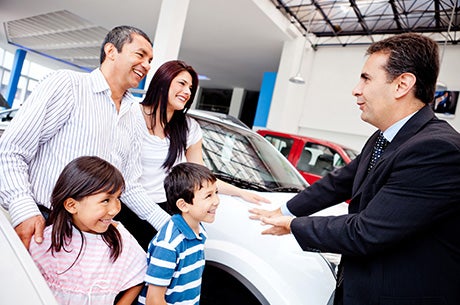 Car dealer helping family