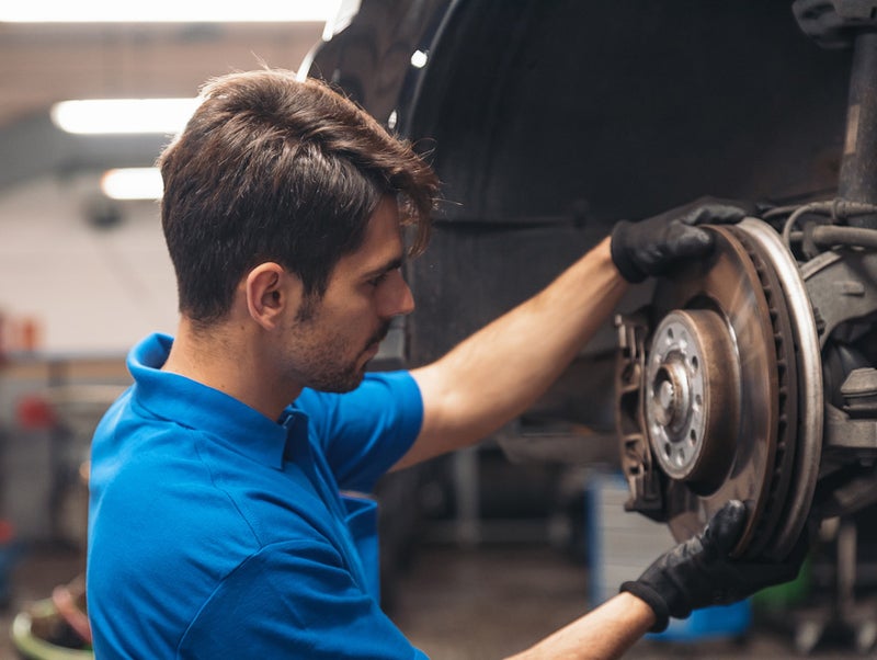 Sales representative working on wheel alignment - Bob Jass Chevrolet in Elburn IL